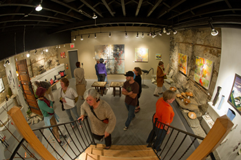 People viewing art in a gallery in Nelson, BC.