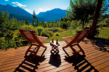 Two chairs on the deck of Wing Creek overlooking Kootenay Lake