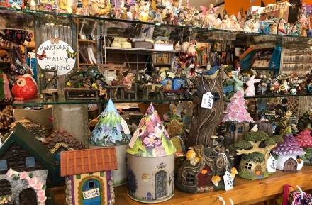 Trinkets, decorations and statues on a shelf at Through The Looking Glass