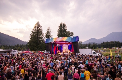 A crowd in front on a colourful stage at Starbelly Jam Music Festival in Crawford Bay, ,BC