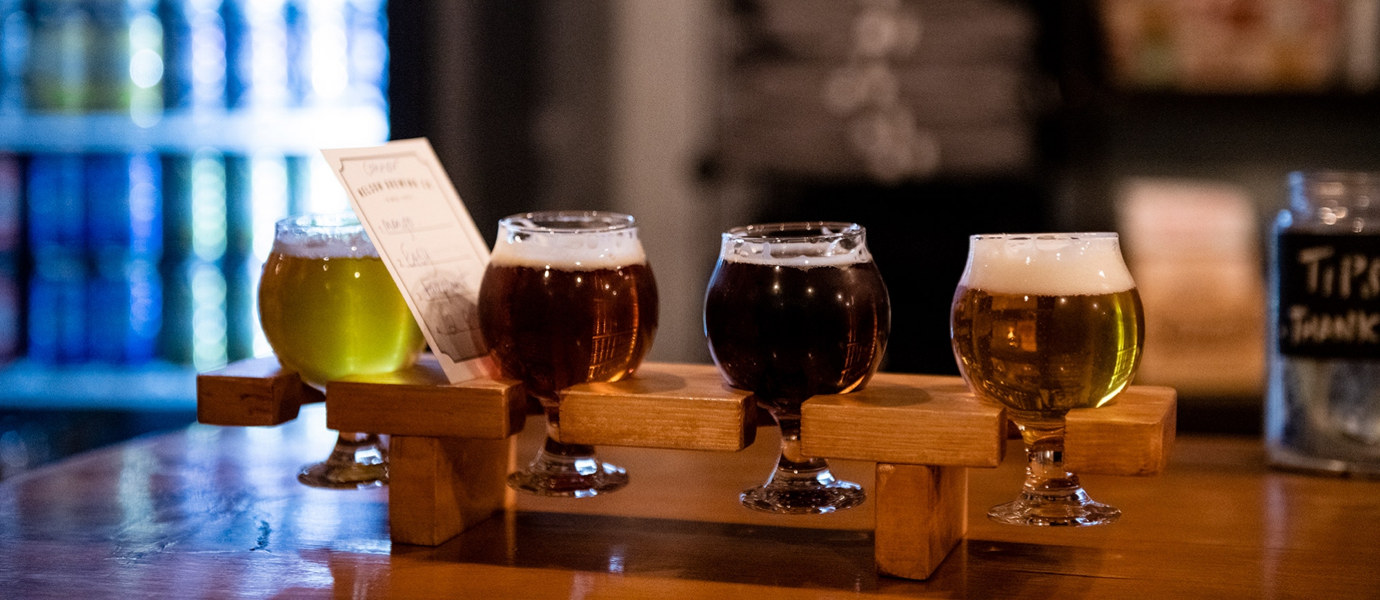 A flight of four beers on the counter of Nelson Brewing Company.