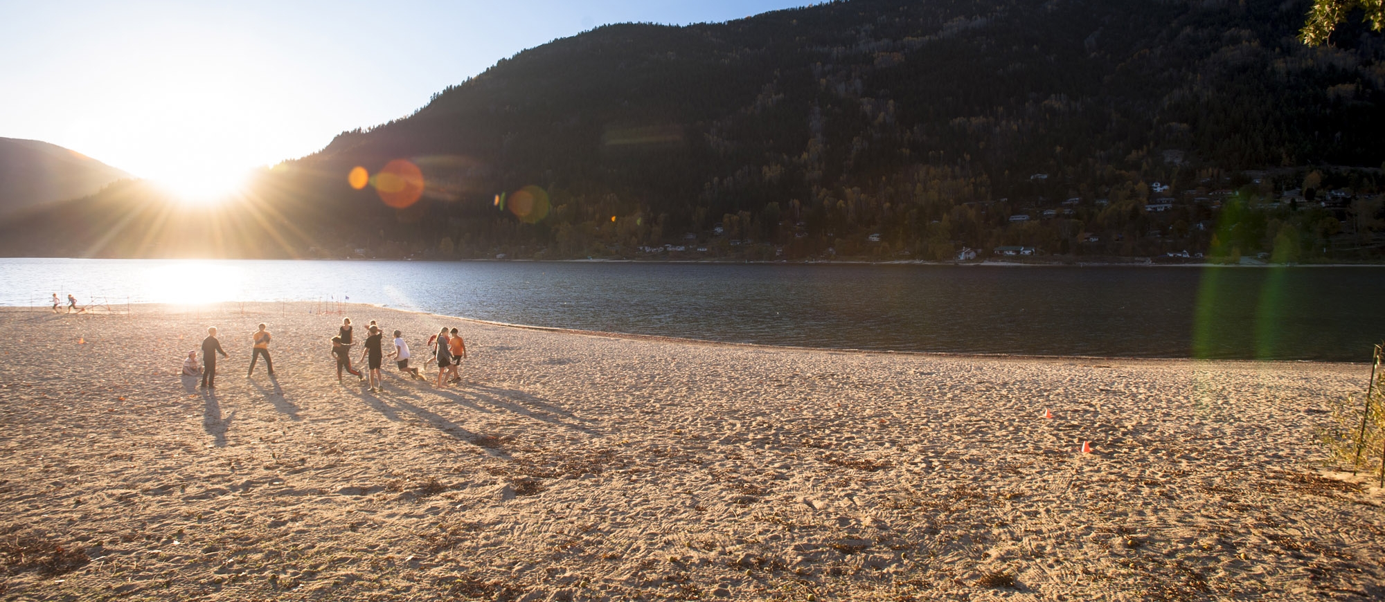 A group playing volley ball on the beach at Lakeside Park in Nelson, BC.