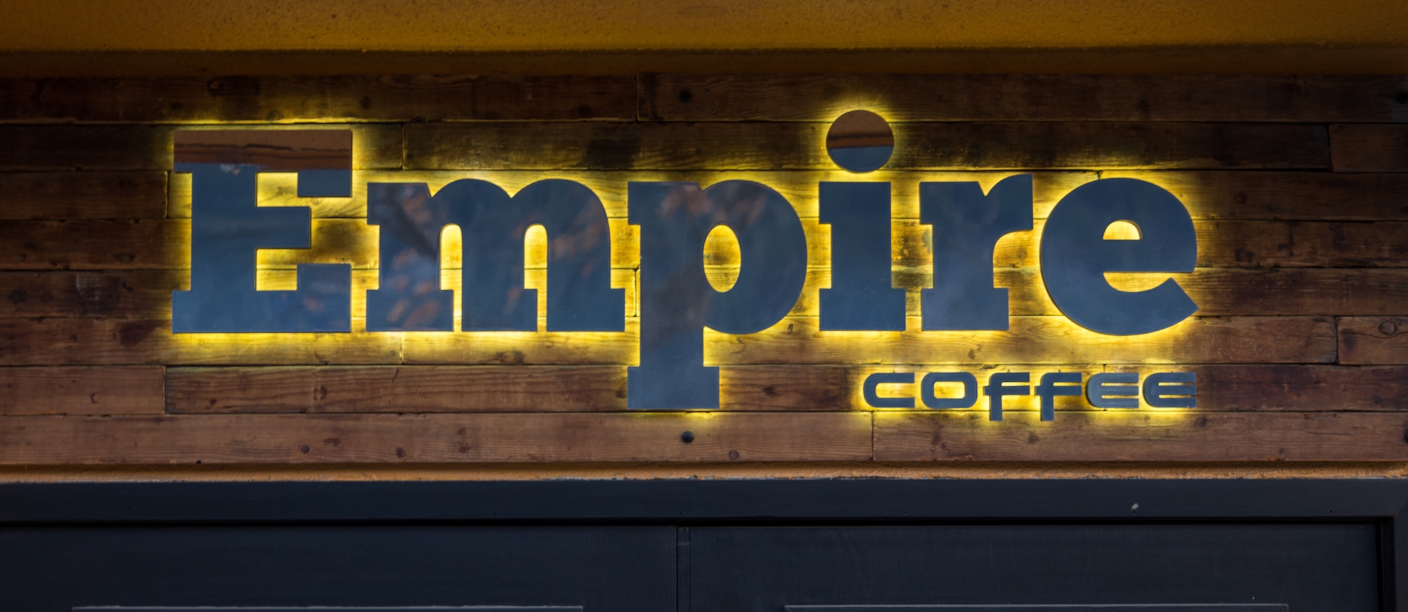 The Empire Coffee sign lit up on the outside of the building