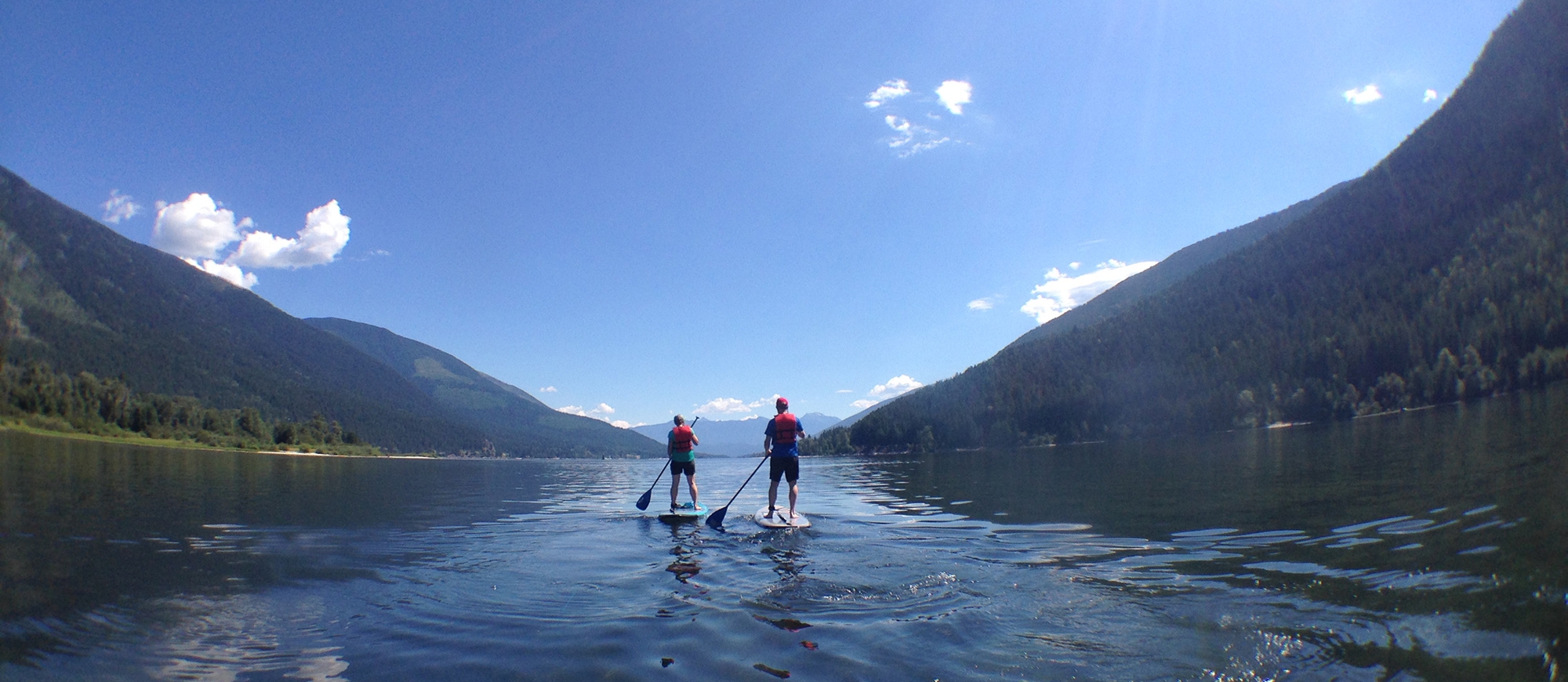 Two paddle boarder out front of Kokanee Creek Provincial Park.