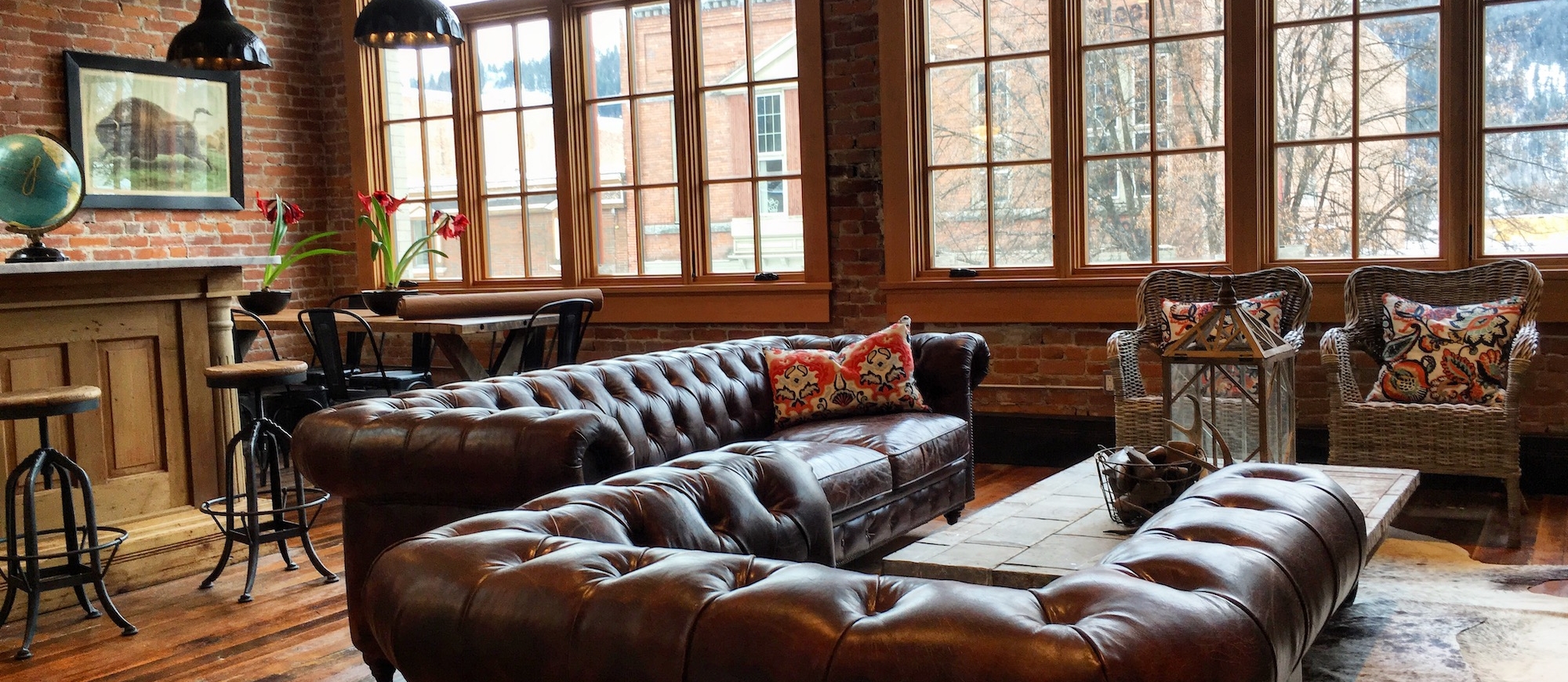 brown leather couches and large windows in the tremont loft 