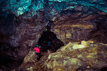 A person standing in the entrace chamber of Cody Caves