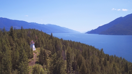 An aerial view of the Pilot Bay Lighthouse and Kootenay Lake, BC