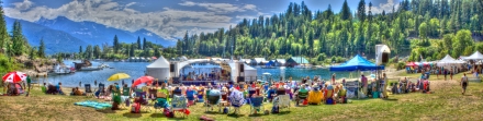 Audience enjoying Kaslo jazz festival stage with mountains and lake in the background