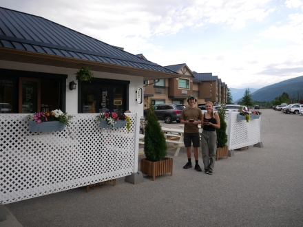 Baristas standing outside Empire Lakeside holding coffees.