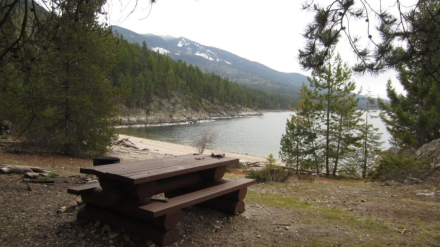 Picnic table and beach at Pebble Beach Rec Site near Crawford Bay