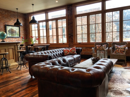 brown leather couches and large windows in the tremont loft 
