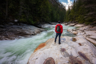 Man standing next to Fry Creek being a responsible traveller.