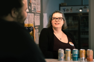 A happy lady working at the Civic Theatre behind the counter