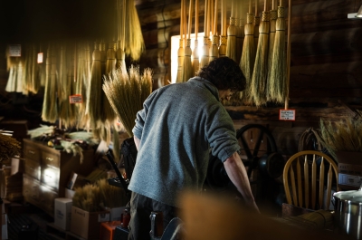 Local broom-maker, Luke, weaving a broom.