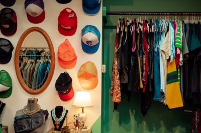 An interior shot of Horse and Snake Vintage, showing a hat display and clothes rail.