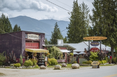 A view of Crawford Bay with artisan shops and mountains in the background