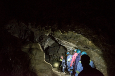 People walking in a cave at Cody Caves near Nelson BC