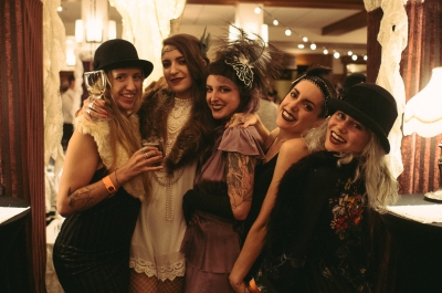 Five women dressed in 20s attire at Grapes & Grains Festival in the Hume Hotel