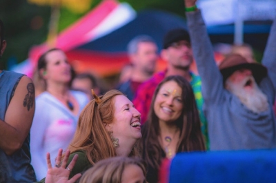 A group of people dancing wearing colourful clothes at Starbelly Jam.