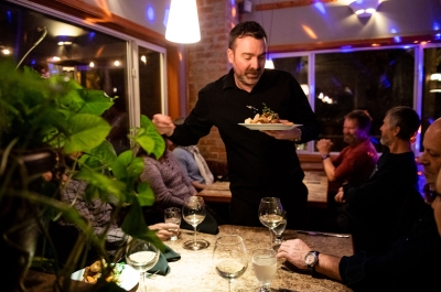 Diners enjoying food at night at Sage Taps and Wine Bar in Nelson, BC