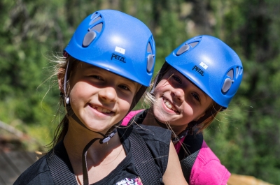 Two children with blue helmets on Kokanee Mountain Zipline near Nelson BC