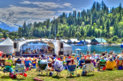 Audience enjoying Kaslo jazz festival stage with mountains and lake in the background