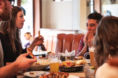 four people enjoying food and drinks at Uptown Sportsbar in Nelson, BC