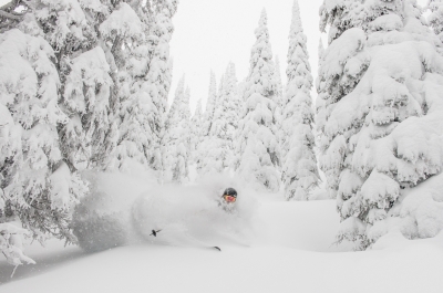 A person skiing in deep powder at Whitewater.