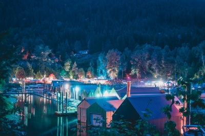 Boathouses in Kaslo, BC lit up with multi coloured lights at the Anuual Kaslo Jazz Etc Summer Music Festival.