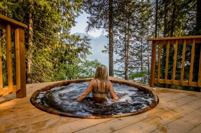 A person in the cedar hot tub at the Sentinel in Kaslo, BC