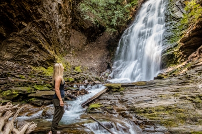 Person viewing beautiful waterfall near Kaslo, BC.