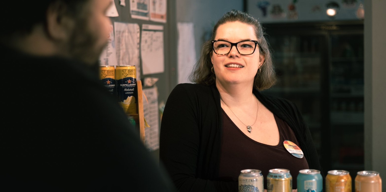 A happy lady working at the Civic Theatre behind the counter