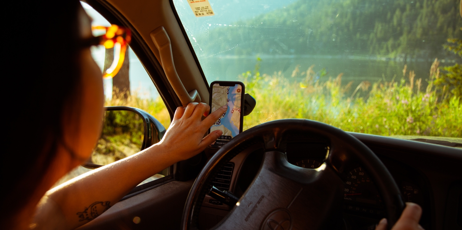 A girl using the Kootenay Lake Road Trip App 