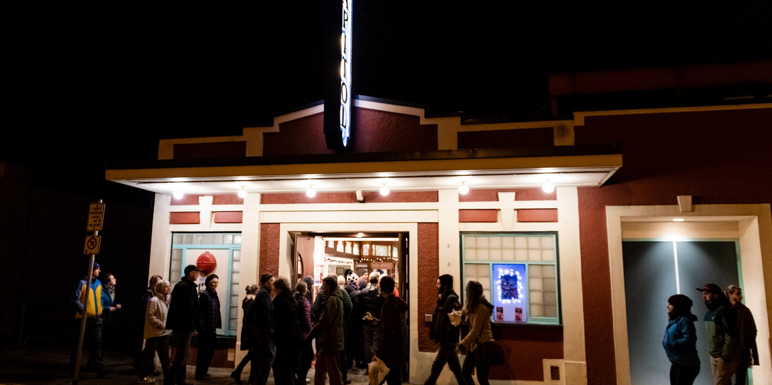 A group of people walking into the Capitol theatre in Nelson, BC