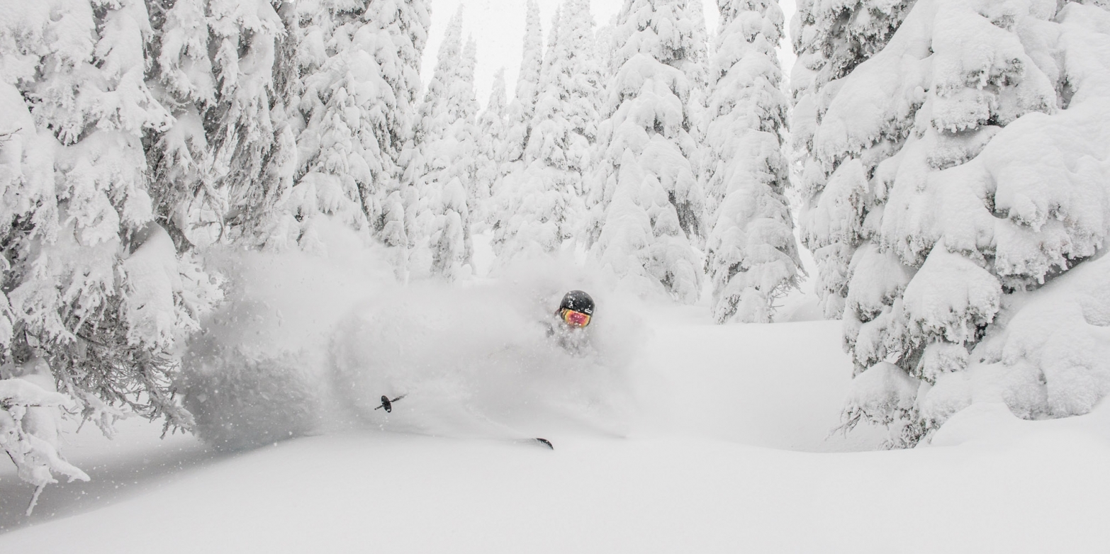 A skiier in deep powder at Whitewater Ski Resort near Nelson, BC.