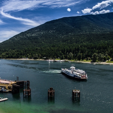 Aerial of the Kootenay Lake Ferry coming into the Balfour Ferry Terminal.