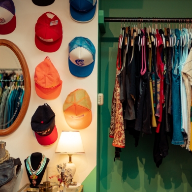 An interior shot of Horse and Snake Vintage, showing a hat display and clothes rail.