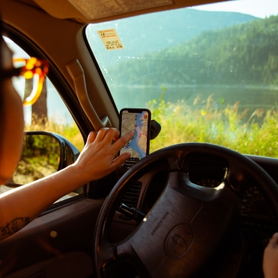A girl using the Kootenay Lake Road Trip App 