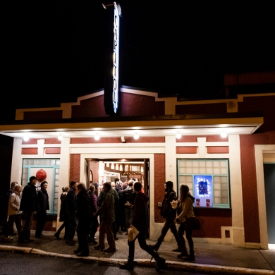 A group of people walking into the Capitol theatre in Nelson, BC