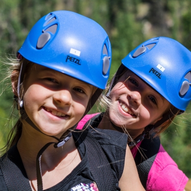 Two children with blue helmets on Kokanee Mountain Zipline near Nelson BC