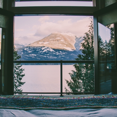 View of snowy mountains from inside accomodation.