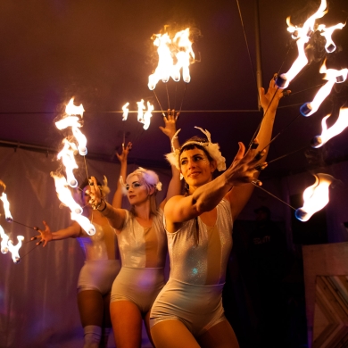 Three fire dancers during Winter Kickoff Festival in Nelson, BC.