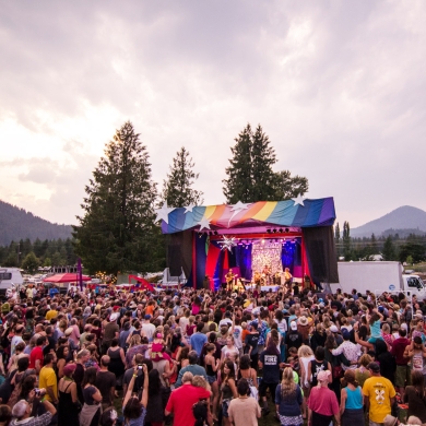 A crowd in front on a colourful stage at Starbelly Jam Music Festival in Crawford Bay, ,BC