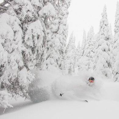 A person skiing in deep powder at Whitewater.