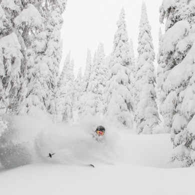 A skiier in deep powder at Whitewater Ski Resort near Nelson, BC.