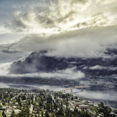 Aerial view of Nelson BC and Kootenay Lake with low hanging cloud.