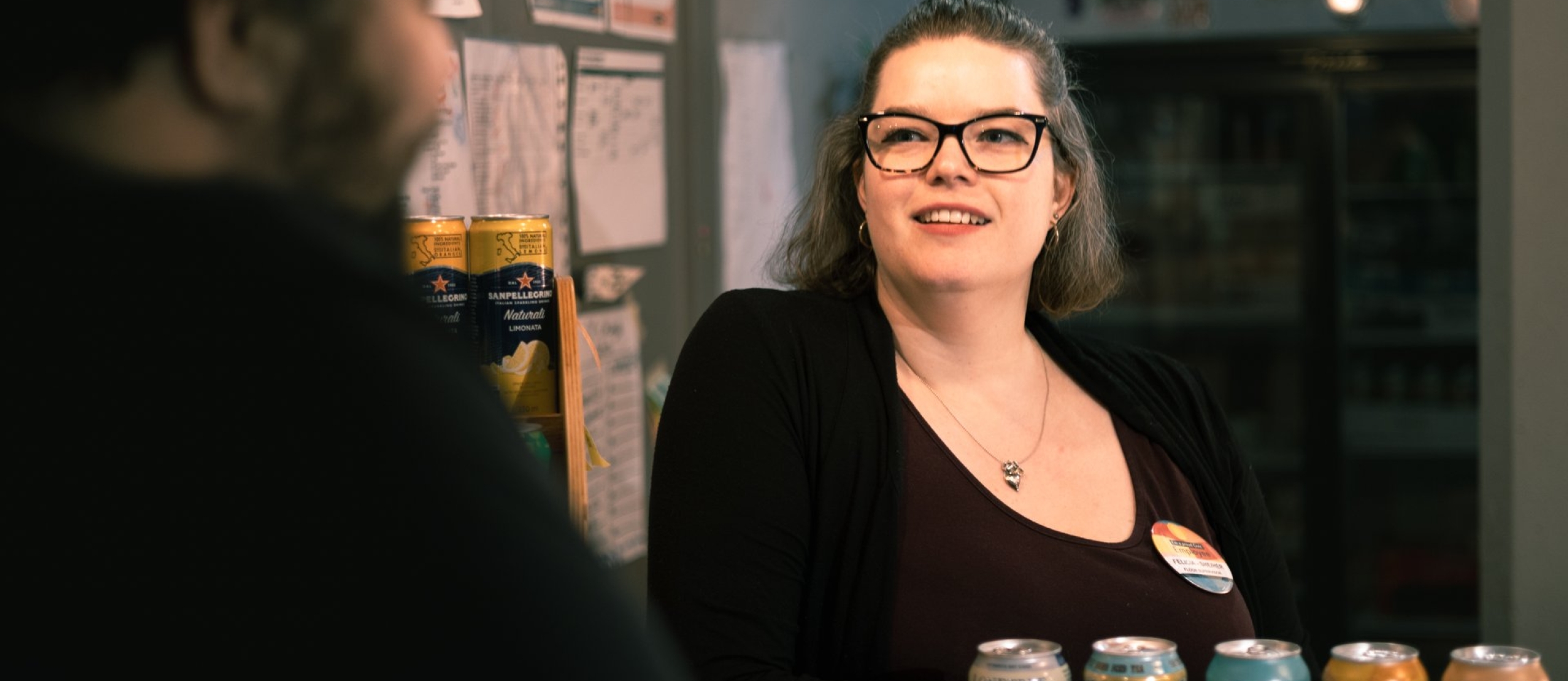 A happy lady working at the Civic Theatre behind the counter