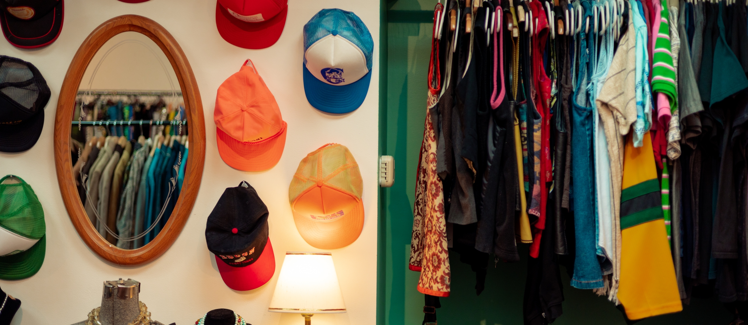 An interior shot of Horse and Snake Vintage, showing a hat display and clothes rail.