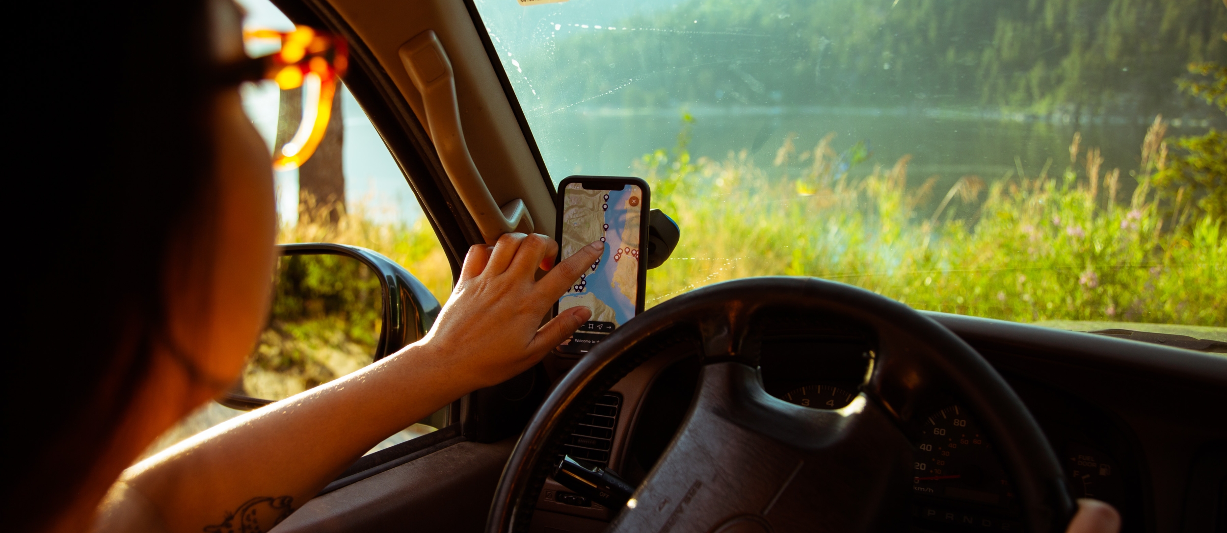 A girl using the Kootenay Lake Road Trip App 