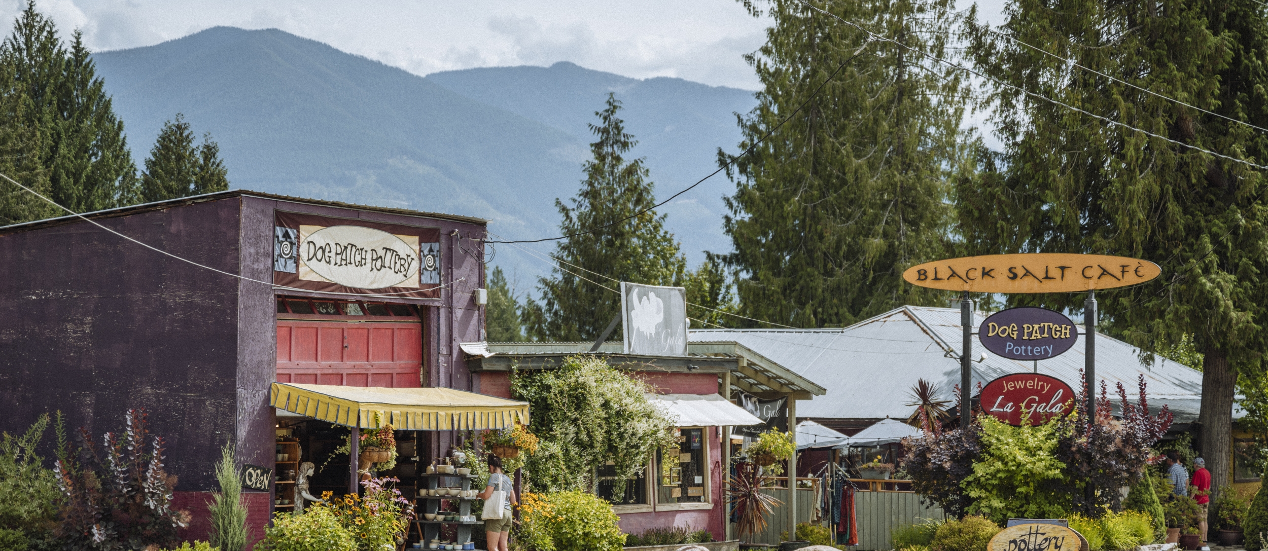 A view of Crawford Bay with artisan shops and mountains in the background